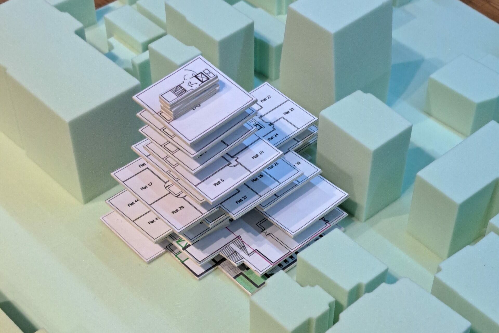 Physical development model of the stepped proposal positioned within a model of the surrounding Seoul buildings.